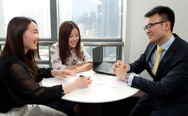 Three people discussing transaction banking services